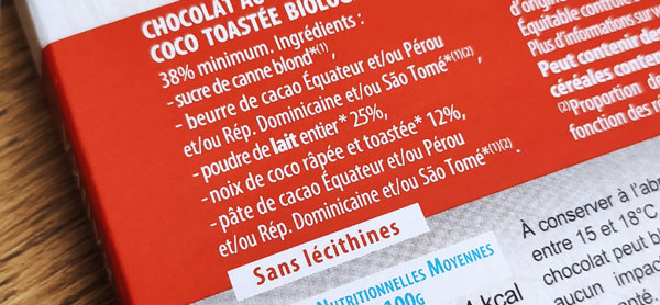 Le dos d'une tablette de chocolat Kaoka. La liste des ingrédients indique l'origine du beurre de cacao et de la poudre de cacao.