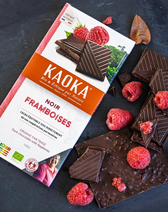 Tablette de la marque Kaoka avec des morceaux de chocolat noir avec des framboises fraîches