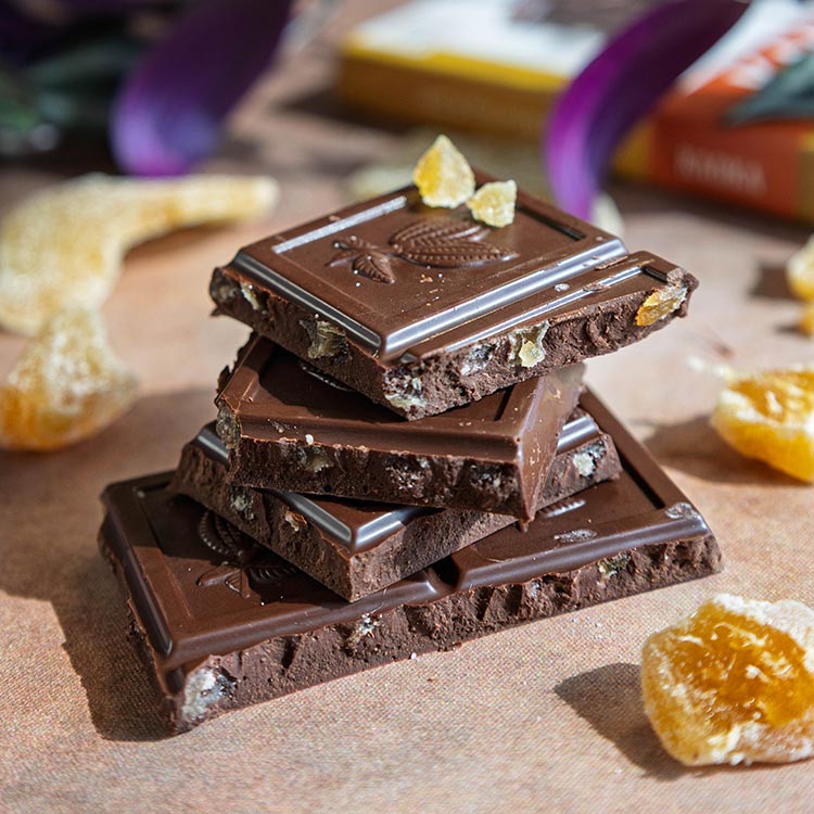 Pile d'épais carreaux de chocolat noir au gingembre confit bio et équitable de la marque Kaoka